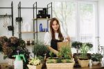 A young woman works in her flower shop. Small business concept.