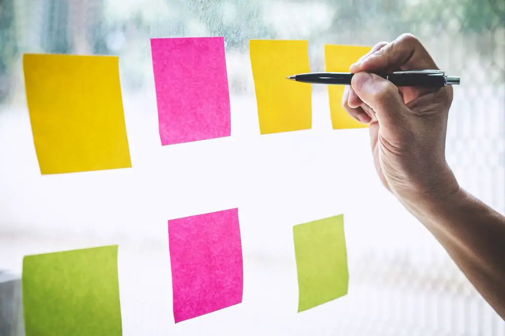 Businessman use post it notes to planning idea and business marketing strategy