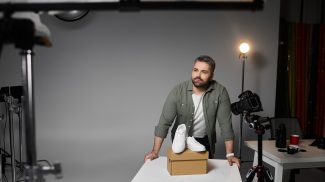 Creative professional capturing product imagery in a studio environment