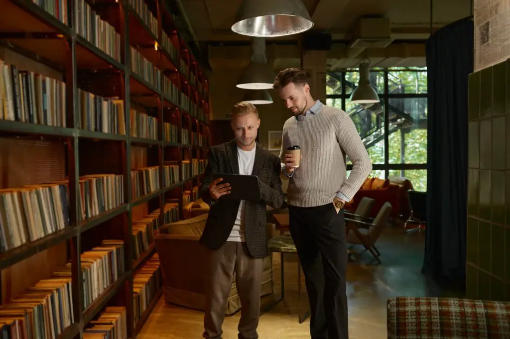 Executive manager showing report on mobile tablet to colleague or team leader