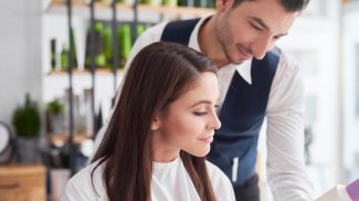 Hairstylist and female customer talking in hair salon