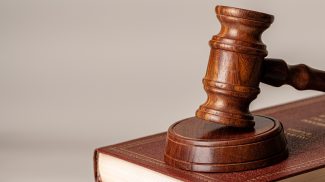 Judge gavel and legal book close up on table