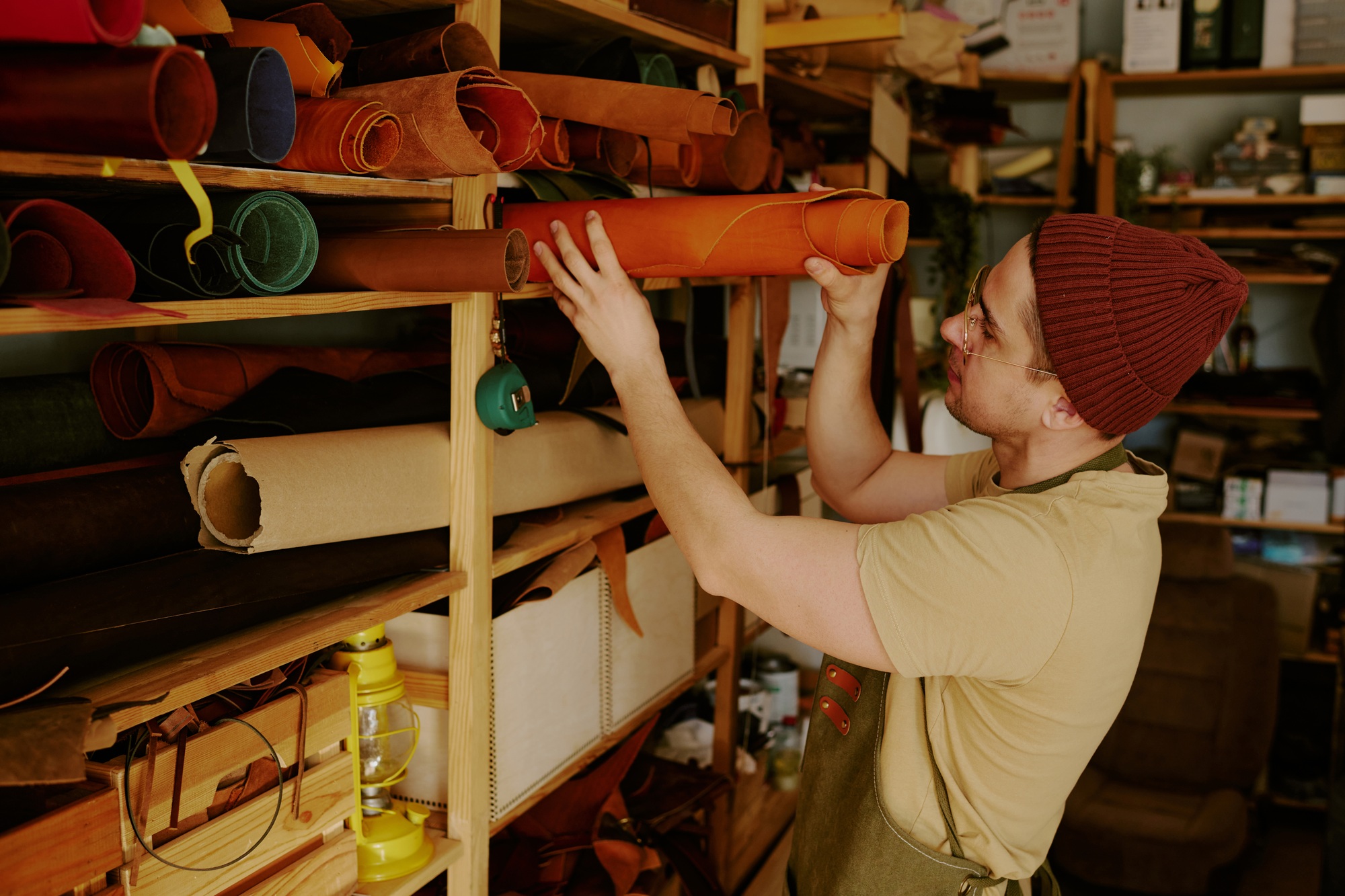 Male Tailor Choosing Leather Roll