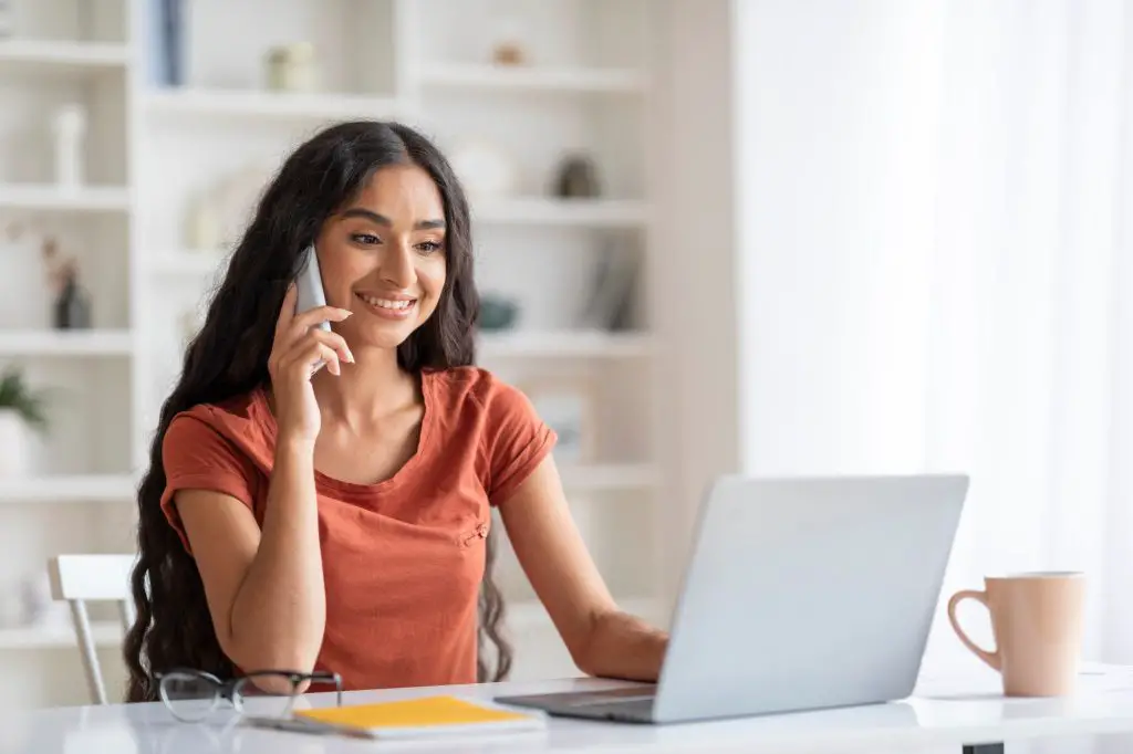 Multitasking Young Indian Woman Engaged with Technology Tools