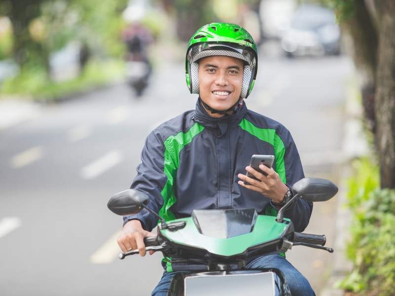 how much money do uber eats drivers make - driver on a scooter