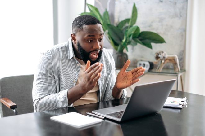 Online video meeting. Serious confident african american man, owner company, sales manager, sits on