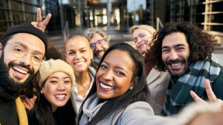 Selfie of a group of happy business people taking photo with a phone