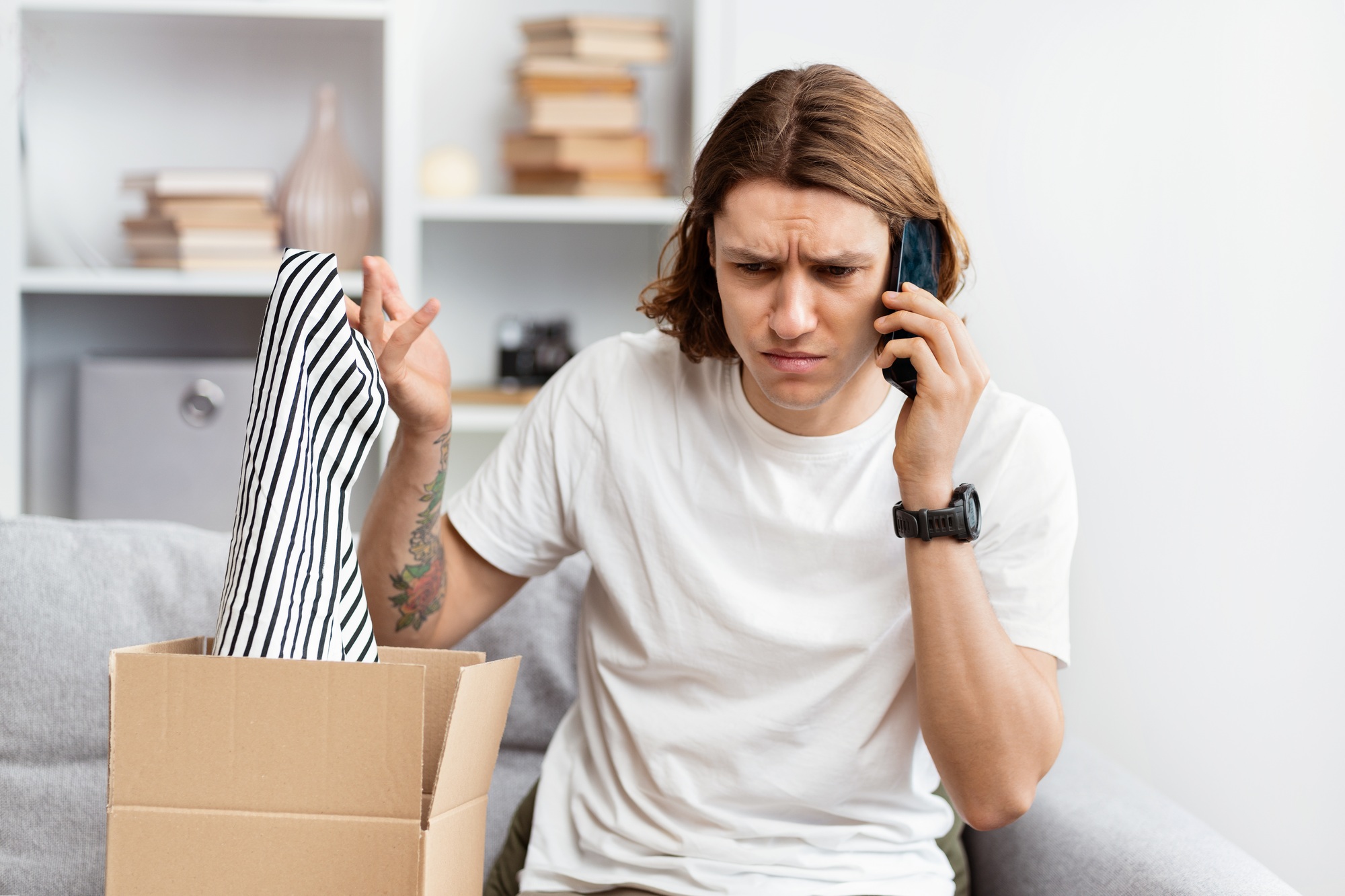 Young Man Feeling Disappointed with Online Purchase Over Phone